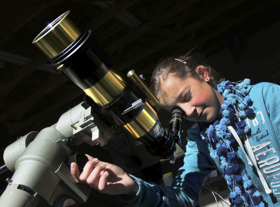 Girl at solar telescope