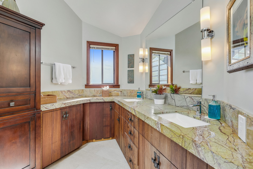 The master bath has dual sinks in a gorgeous green marble counter. Ocean view from the window!