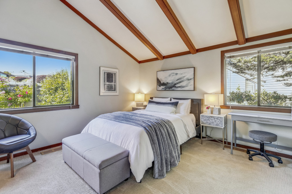 Secondary master bedroom with a cozy queen size bed and vaulted ceilings.