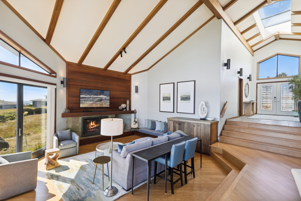 The open floor plan has vaulted ceilings and exposed beams in the main living space.