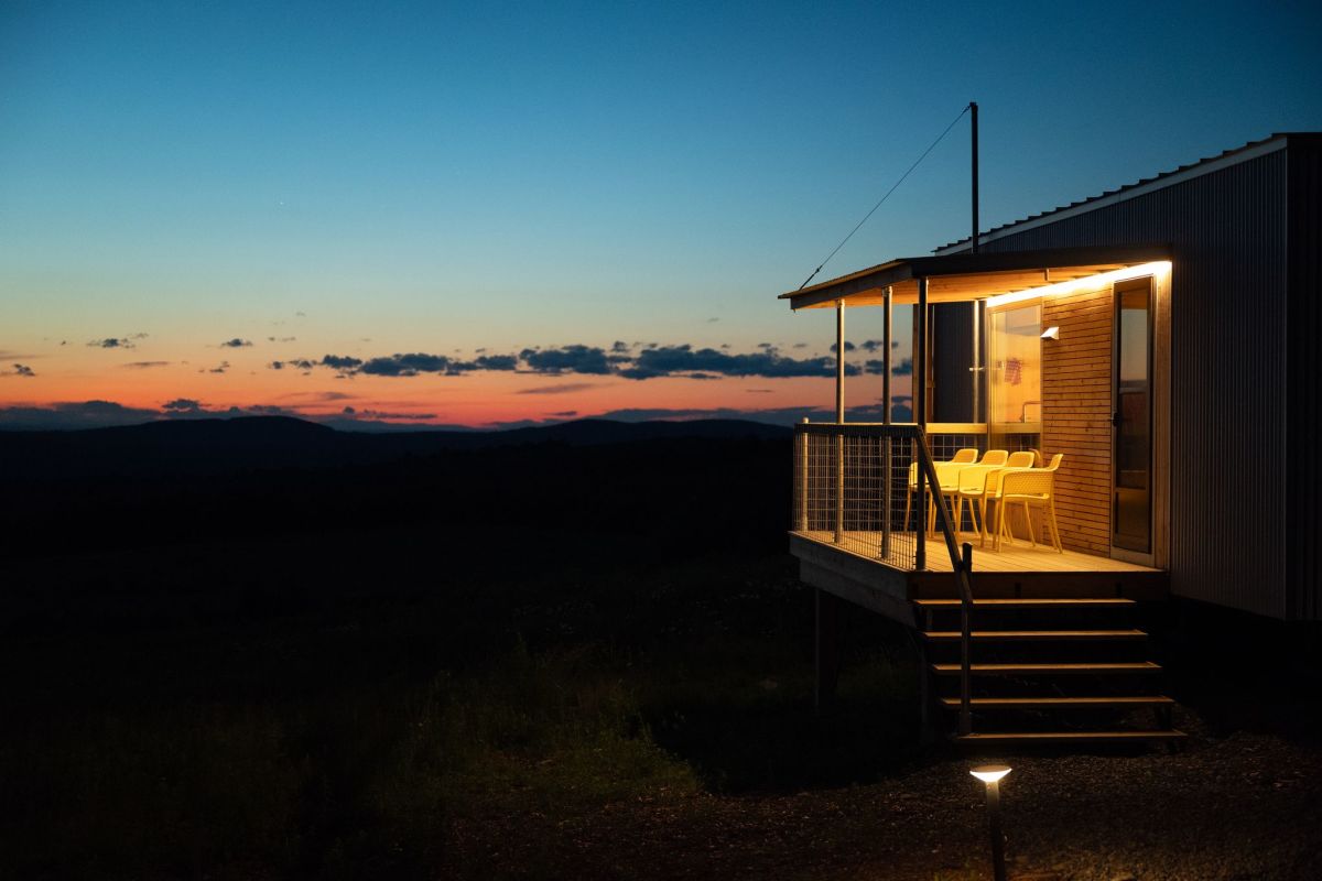 A Field Cabin at sunset, highlighting the sailboat-inspired galvanized steel 