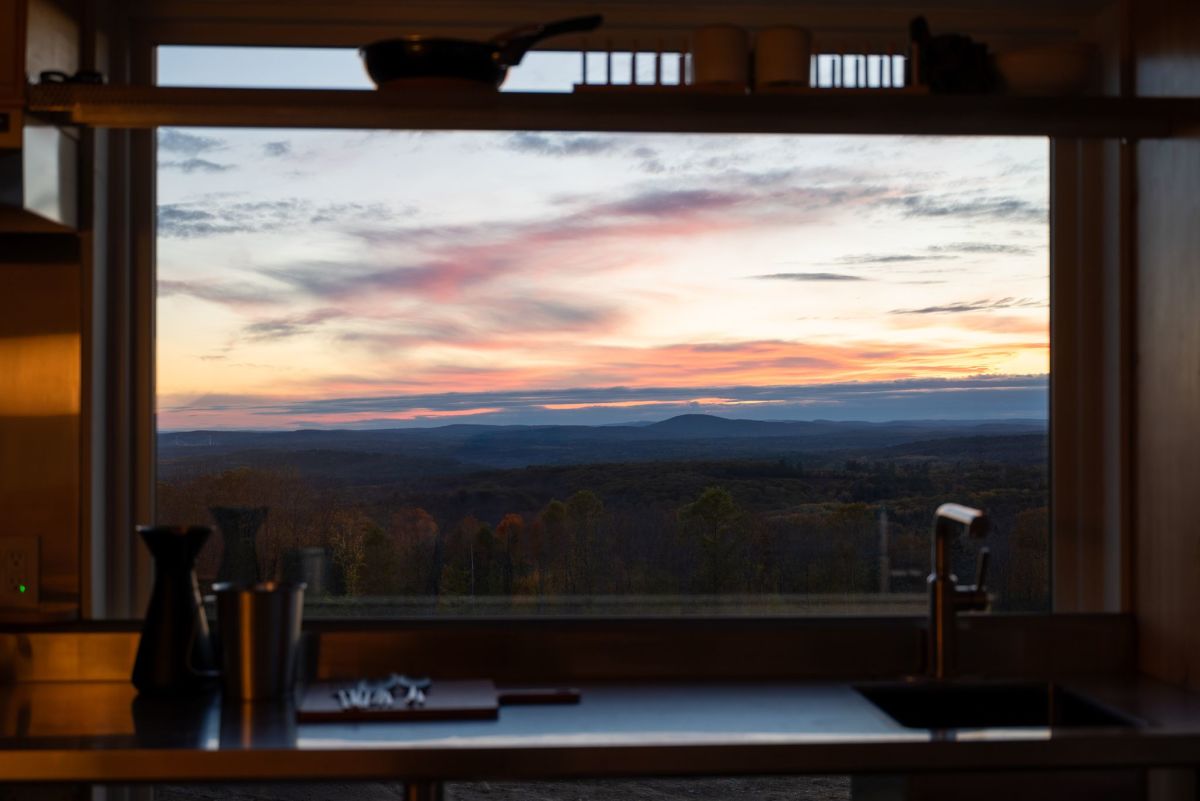 Inside the cabin kitchen, where clean contemporary detailing and expansive picture windows frame stunning 100-mile views extending to Penobscot Bay and Mt. Katahdin.