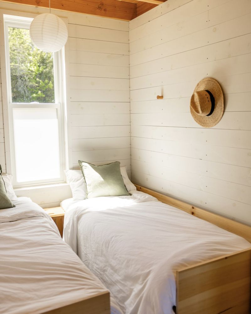 The cozy kids' bed nook tucked off the main entryway, featuring two twin beds with privacy curtains. Specifically designed to make traveling with children seamless.
