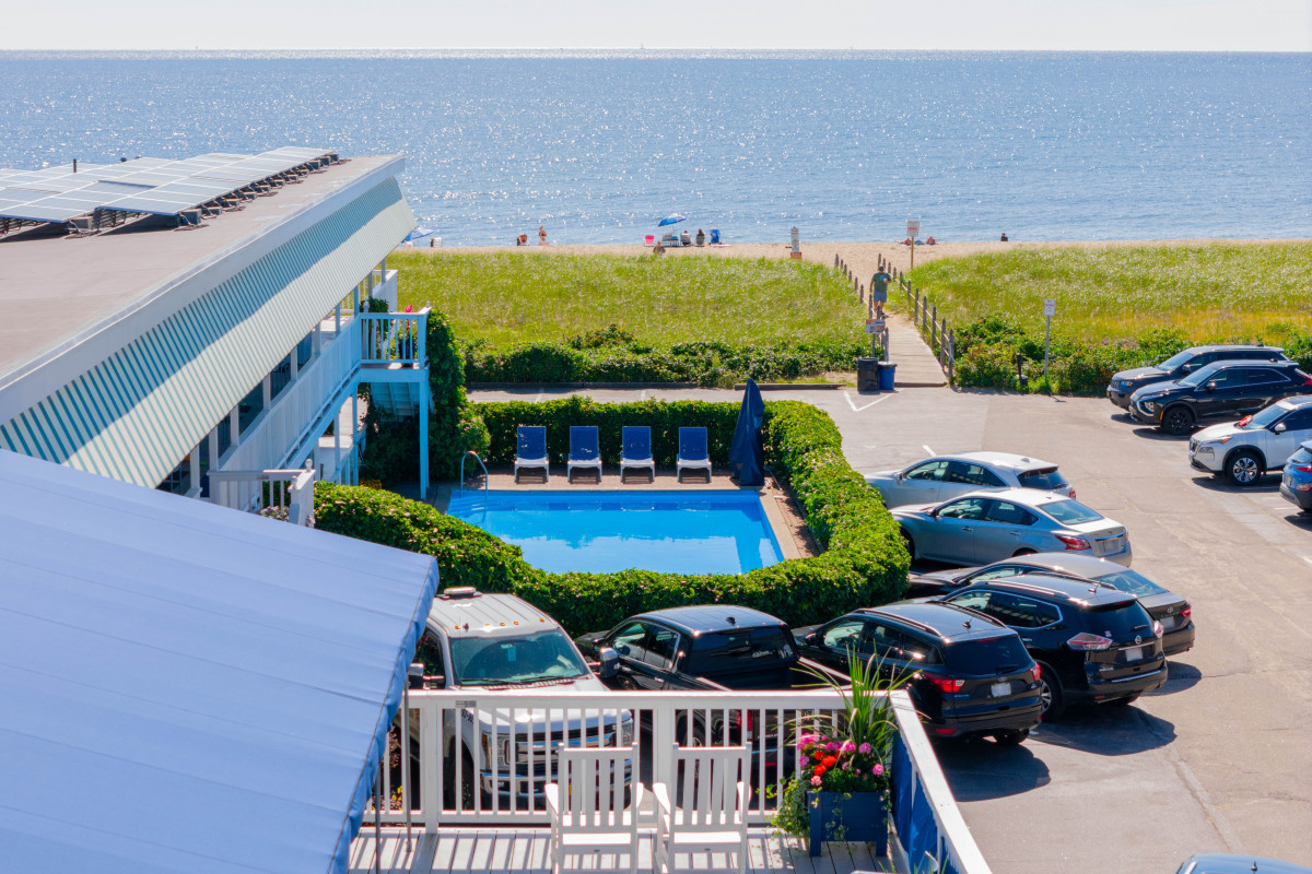 The exterior of the Edgewater with a beach view and pool.