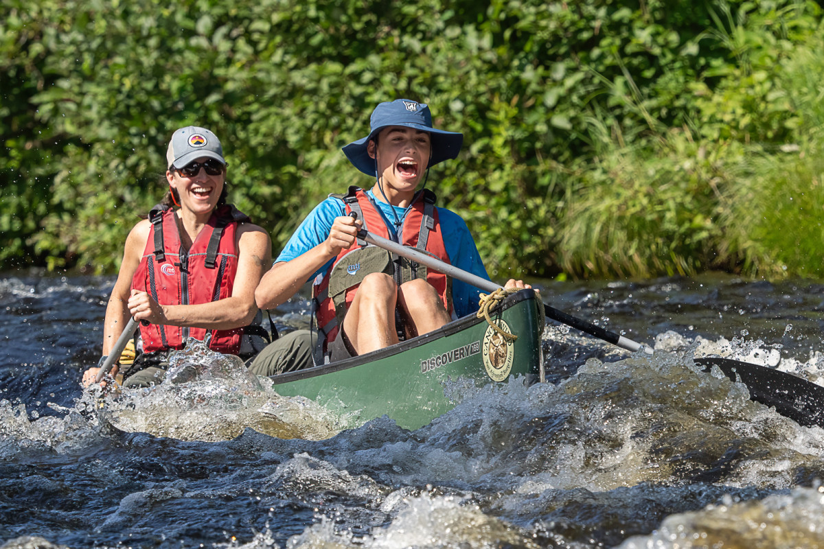 Mother and son paddling lively but not too extreme Chase Stream Rapids as part of a 5 day and 4 night guided and outfitted canoe trip