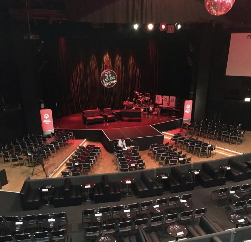 Seated performance with stage set and extended stage