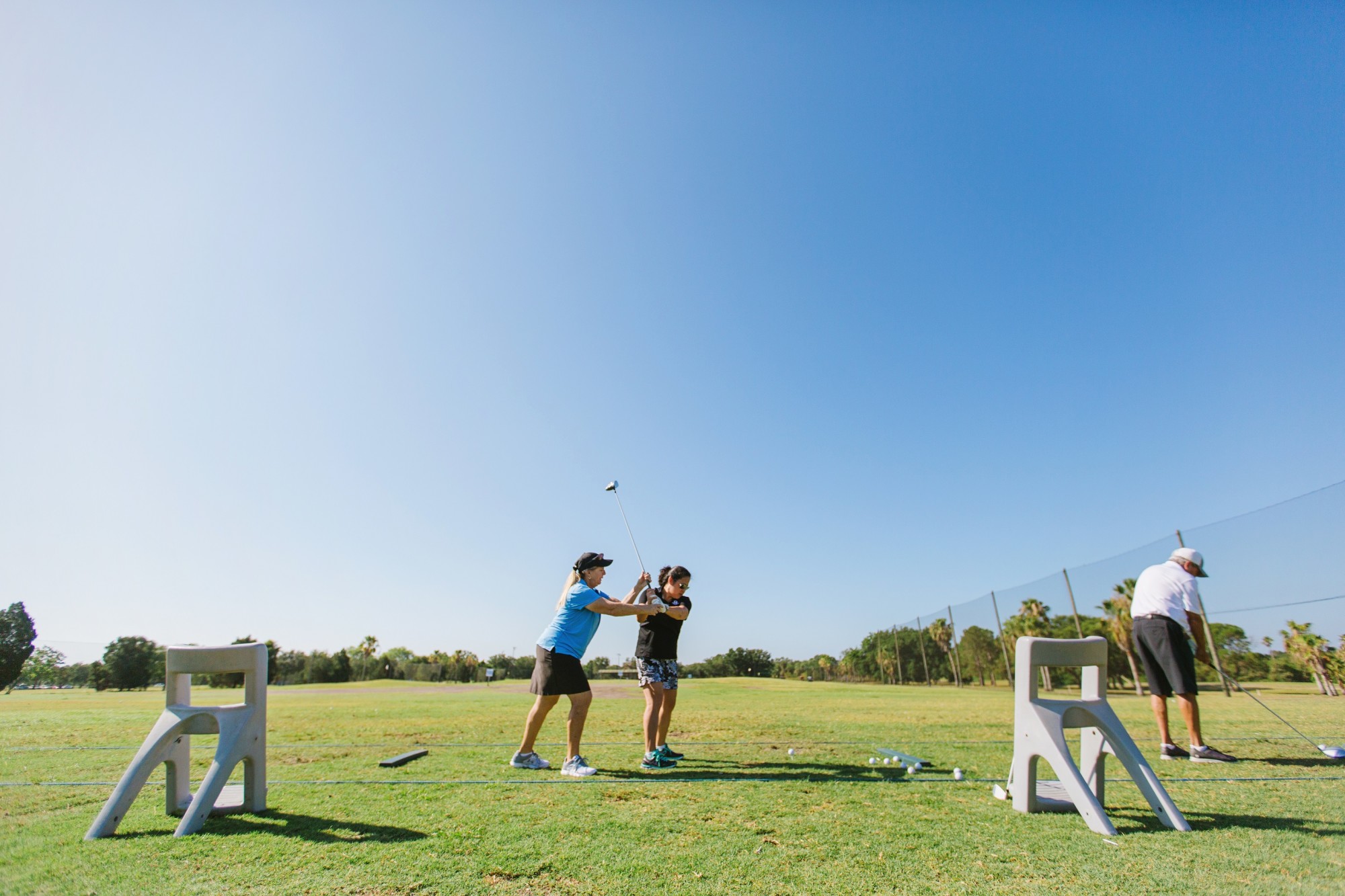 Charlaine Tatz, PGA Teaching Professional at Twin Brooks coaches a player on her swing