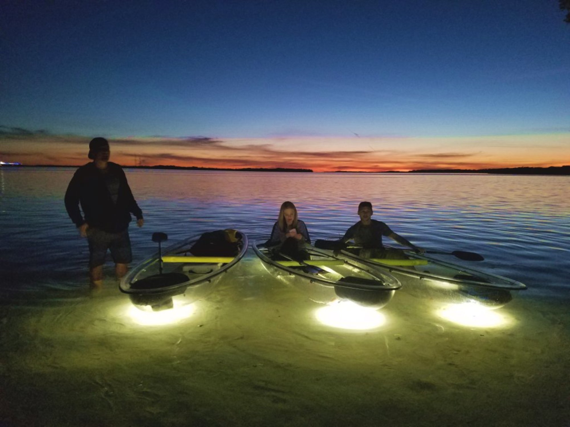 Arriving in our clear kayaks after sunset tour with the lights on.