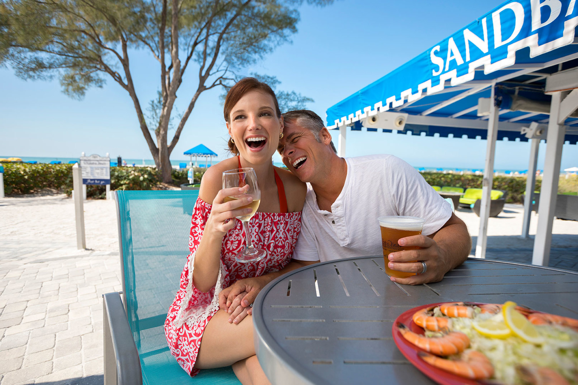 Sip on a drink with your toes in the sand at the popular SandBar.