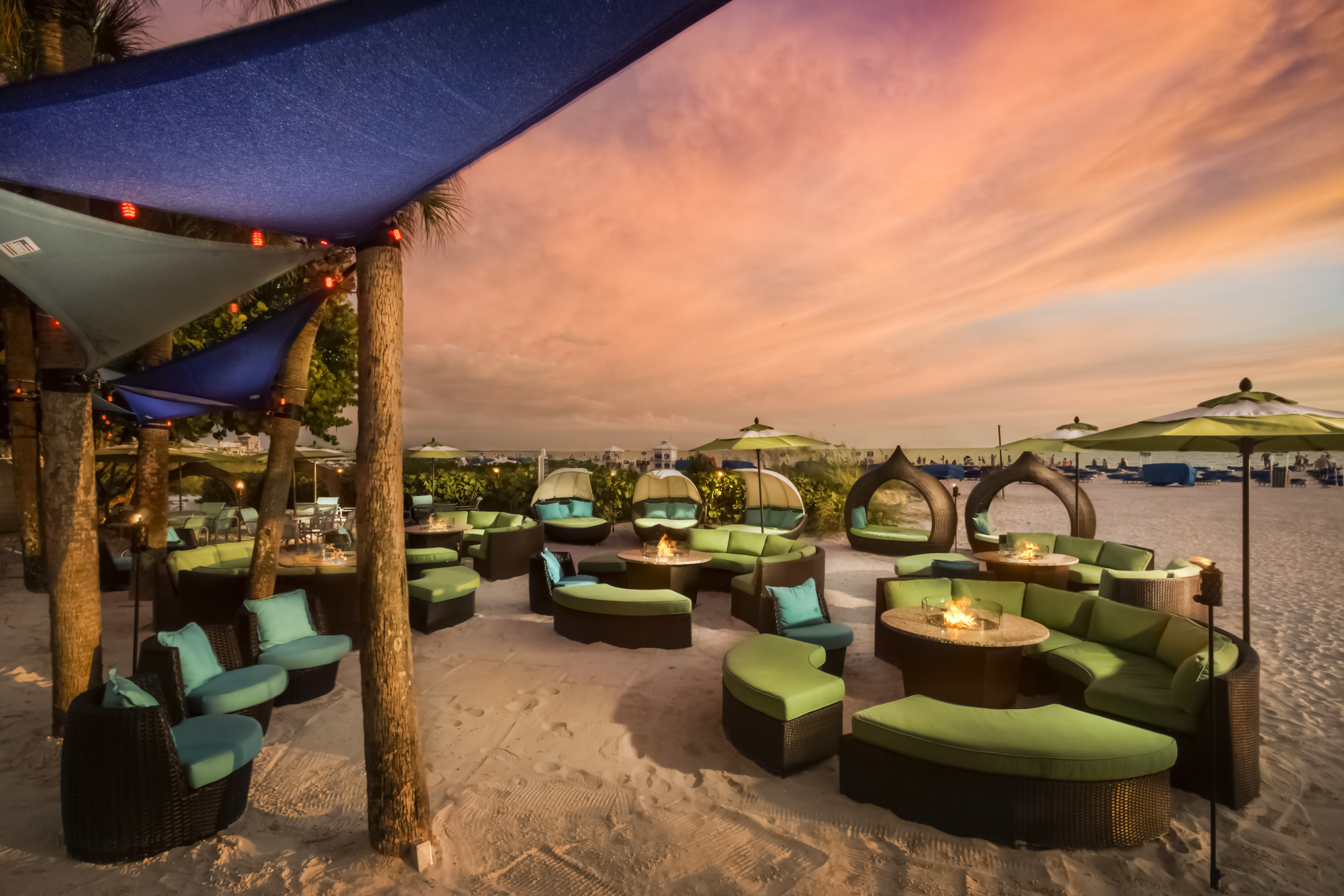 Sip on tropical drinks and listen to live music at Salty's Tiki Bar and beach lounge