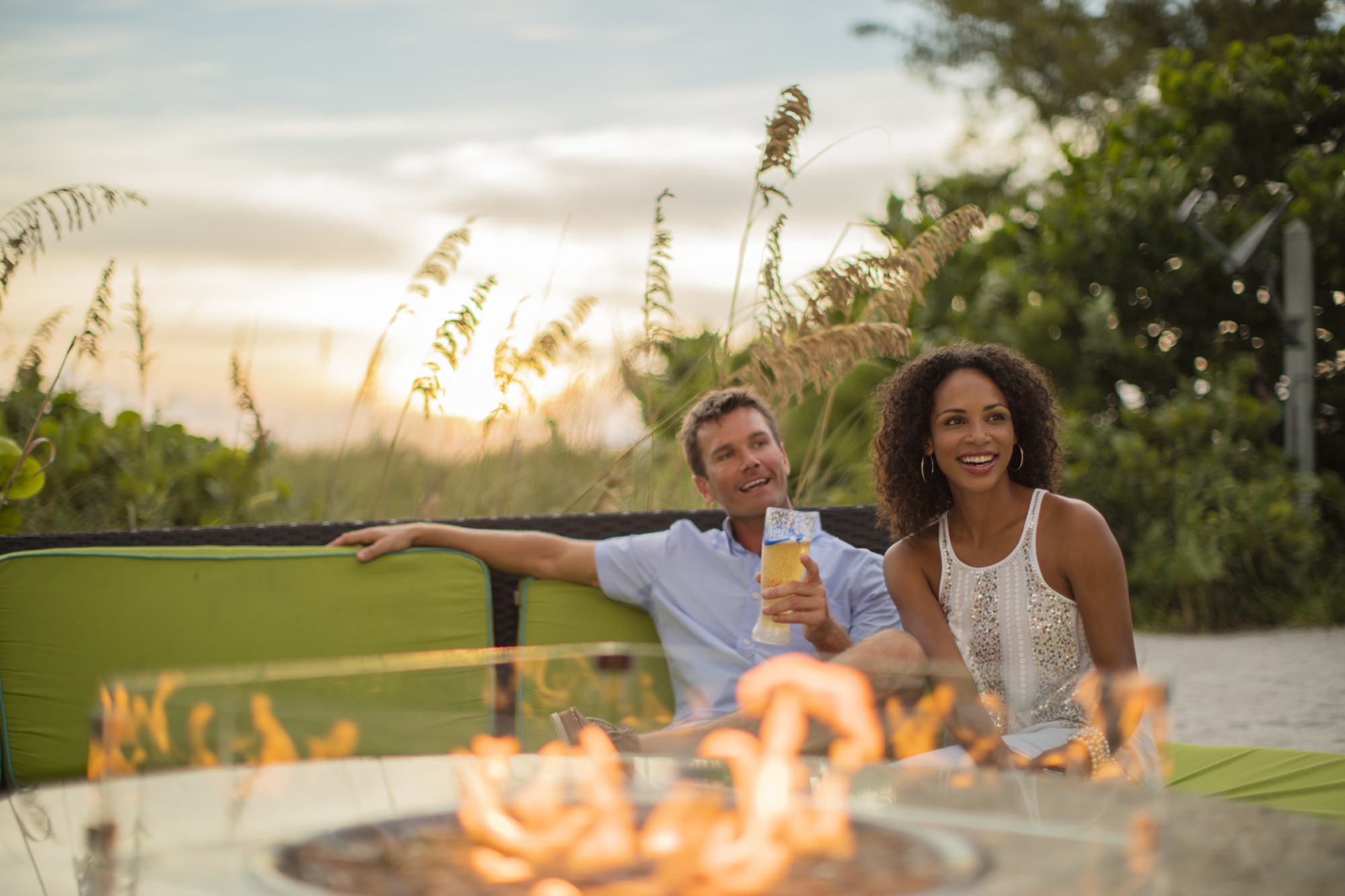 Relax around open fire tables at The SandBox Beach Lounge