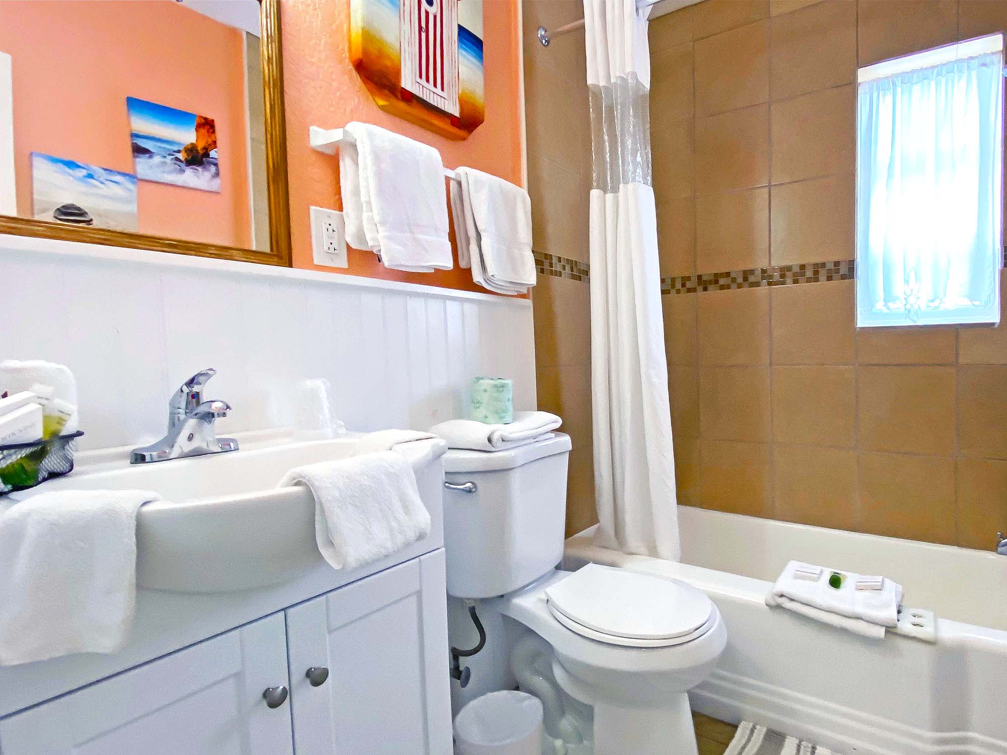 bathroom with a shower and a tub