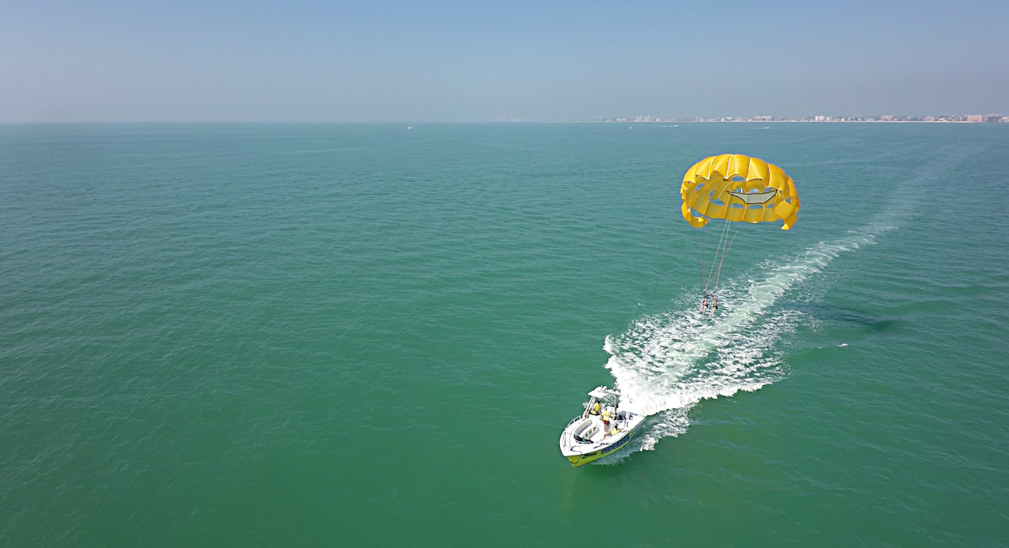 Aerial view of a pair of people parasailing