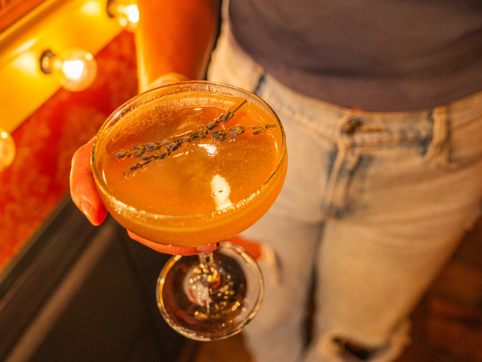 Woman holding cocktail at Gigglewaters