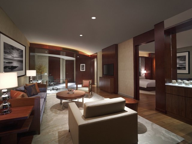 Grand Suite - Living Room - Immerse in 105 sq m suite with one king bed and either city or twin towers view, living room, luxurious bathroom fitted with oval-shaped marble bathtub and Grand Club lounge access.