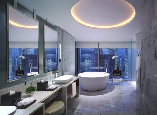 Grand Suite - Bathroom - Immerse in 105 sq m suite with one king bed and either city or twin towers view, living room, luxurious bathroom fitted with oval-shaped marble bathtub and Grand Club lounge access.
