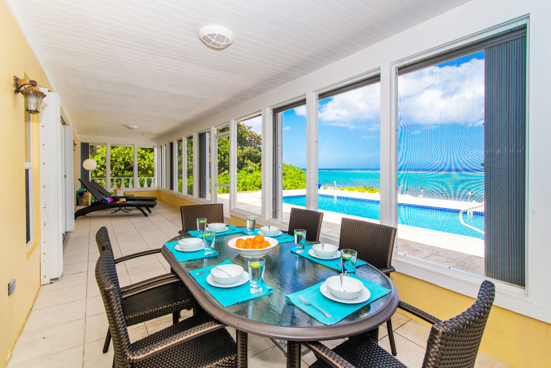 Exterior patio with dining and views of the pool and beach