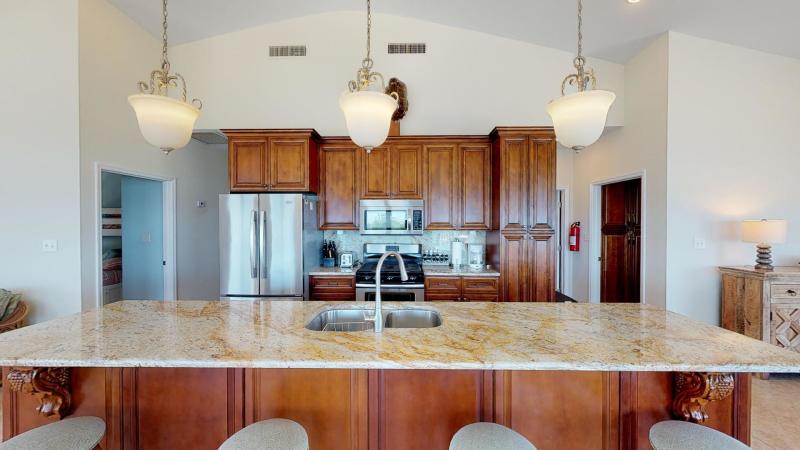 Kitchen is fully equipped with eat-in island