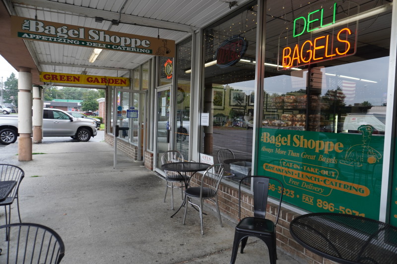                         The door is open, welcoming visitors inside The Bagel Shoppe.
                        