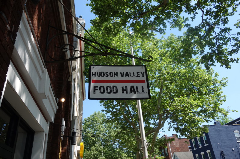                 The hanging sign for the Hudson Valley Food Hall on Main Street in Beacon.
                