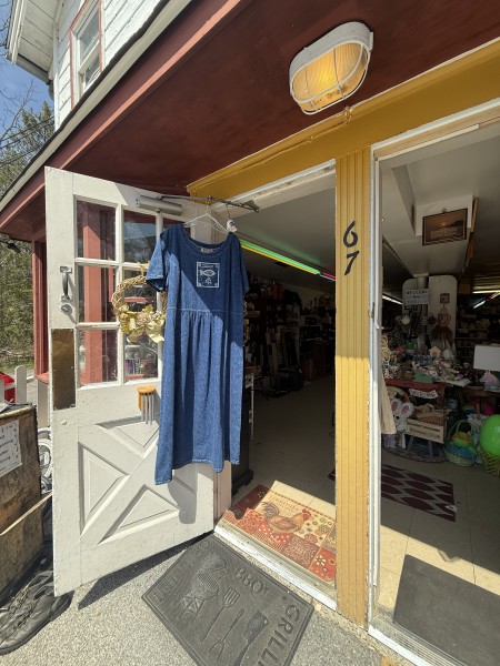                         The front entrance of Red Hook Yard Sale with a blue dress hanging from the door frame.
                        