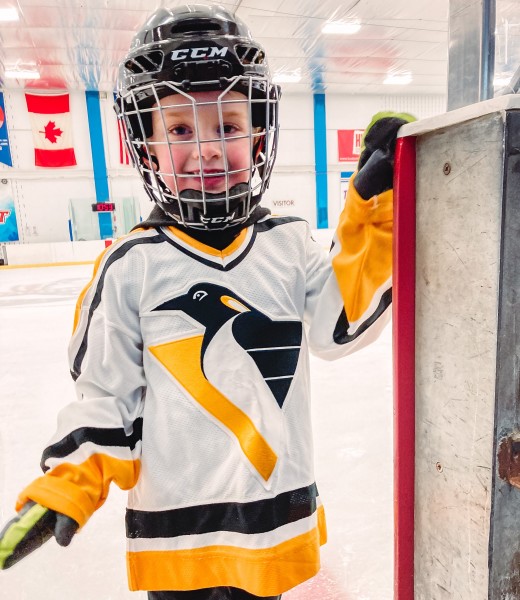                        A young skater wearing a Pittsburgh Penguins hockey jersey and a black hockey helmet with a metal facemask at the McCann Ice Arena at the MJN Convention Center in Poughkeepsie
                        