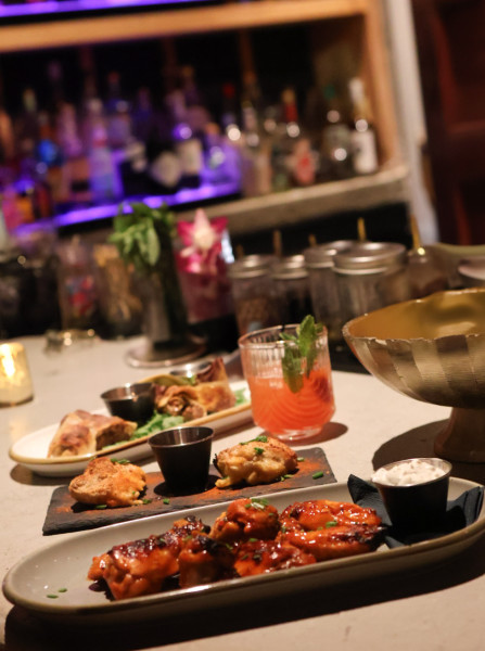                         Plates of food and a cocktail on a table at day&nite lounge in Wappingers Falls.
                        
