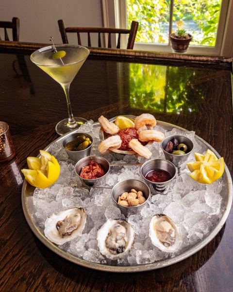                         A player of oysters and shrimp on ice alongside a martini at Panacea in Amenia.
                        
