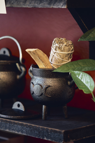                         Miniature cauldron containing herbs.
                        