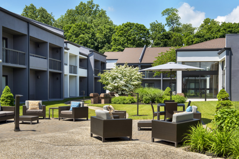                         The outdoor patio at the Courtyard by Marriott Poughkeepsie with patio furniture on a sunny day.
                        