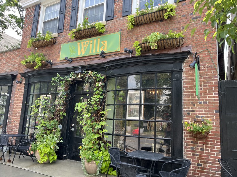                         The brick front of Willa in Millerton with the green sign above the door.
                        