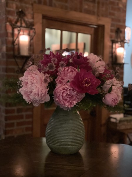                         A vase filled with colorful peonies on the bar at Willa in Millerton.
                        