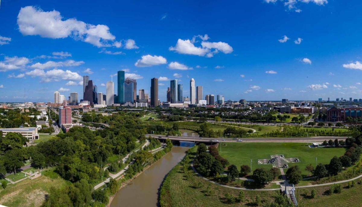 Houston skyline rising beyond Buffalo Bayou parkland