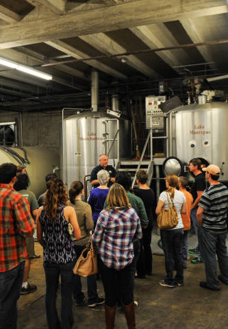 Visitors listen intently during a Tin Roof Brewery tour in Baton Rouge, Louisiana.