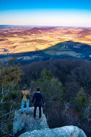 Hikers look out over the view from the Pinnacle
