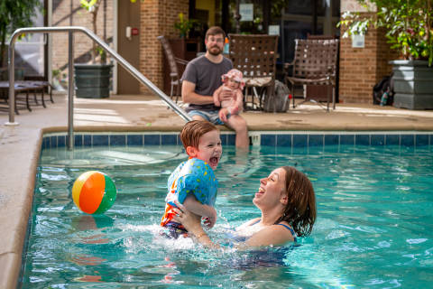 Mom and son playing in a pool