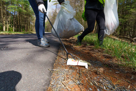 Trash being picked up along the road