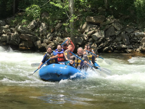 a group of people is white water rafting