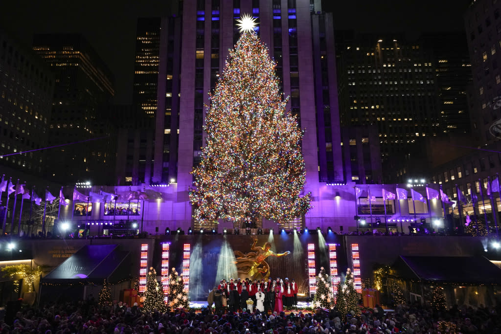 Iconic Christmas tree at Rockefeller Center illuminated in midst of pro ...