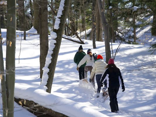 Winter outdoor recreation gear including snowshoes and winter clothing for frozen adventures