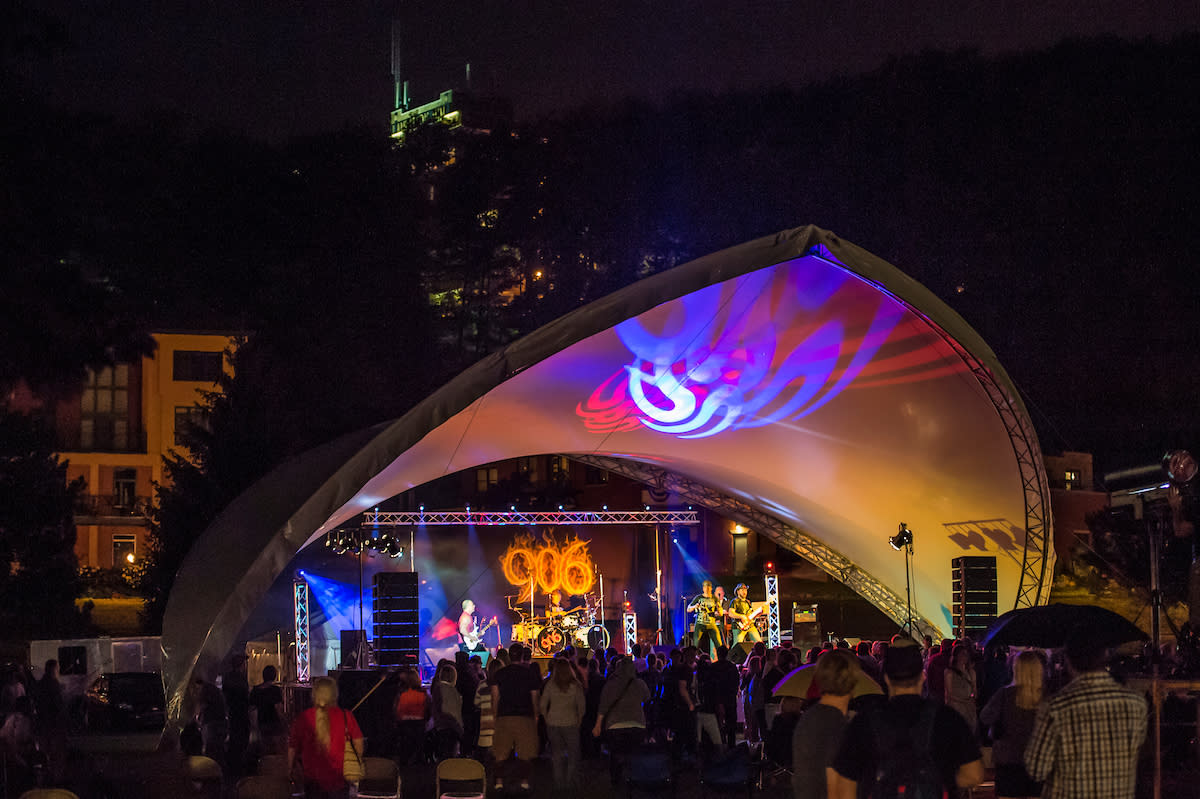 Outdoor concert stage at evening with colorful lights