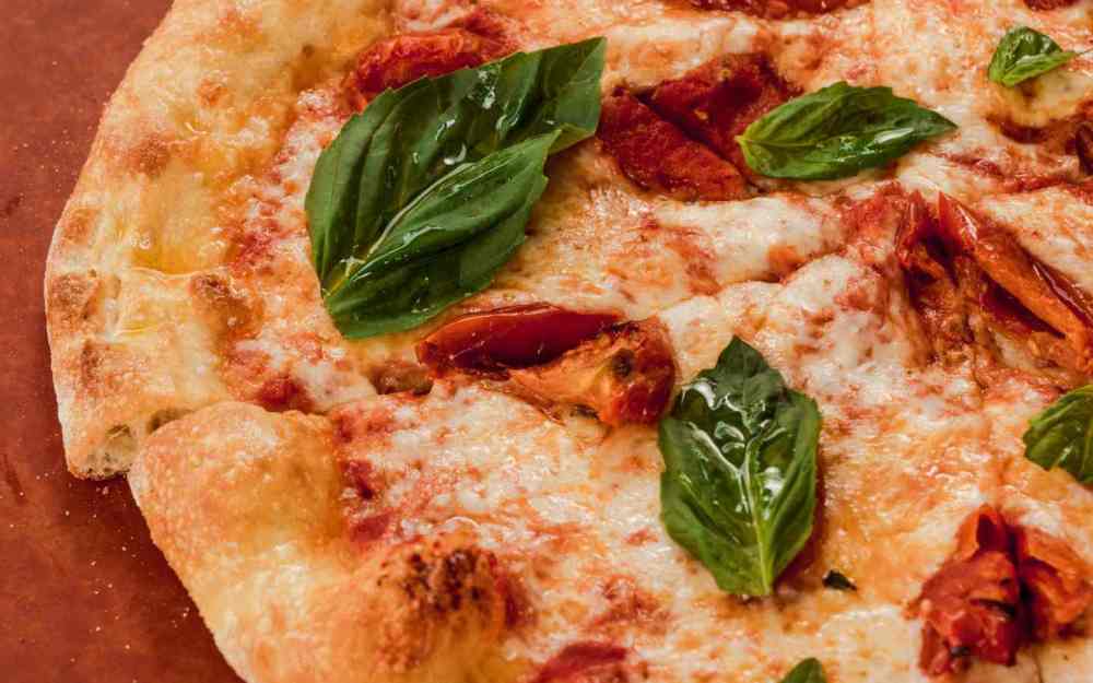 Indulge in our Margherita Pizza at Freestyle. Fresh, flavorful, and ready to savor under the sun!