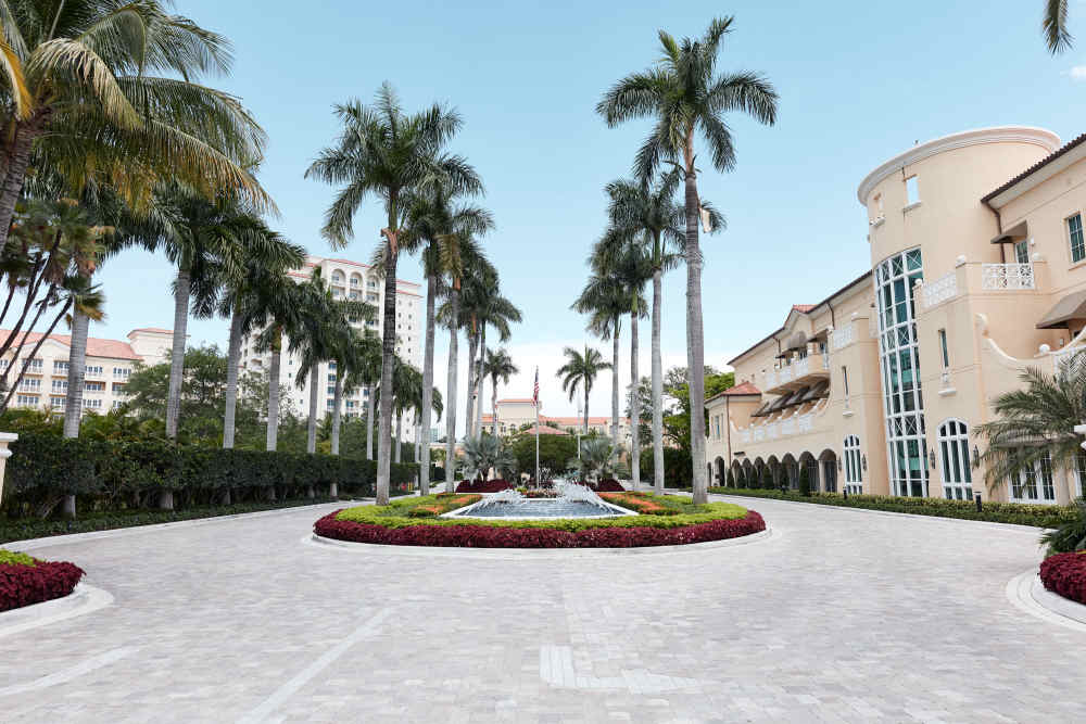 You're greeted by the picturesque driveway of a waterfall, swaying palm trees, and vibrant flowers that takes you to valet or self-parking garage.