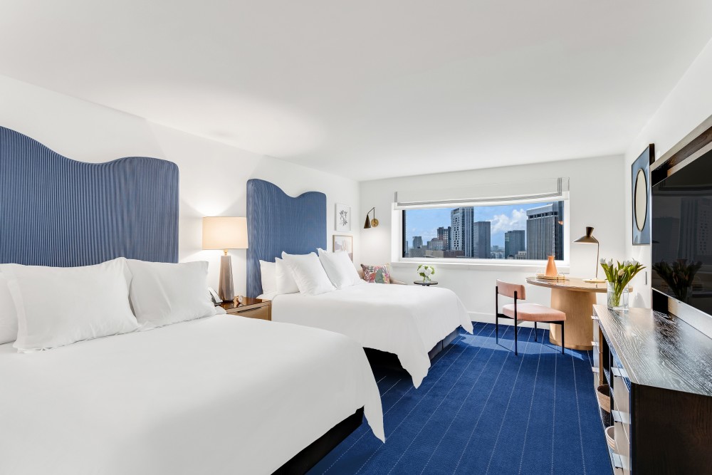 The Two Queen Skyline View King room ft. two plush queen beds spacious for four adults, power blackout shades, Nespresso machine & more.