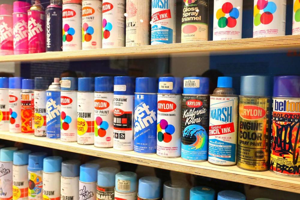 The museum features many artifacts, including a large wall of vintage spray cans!