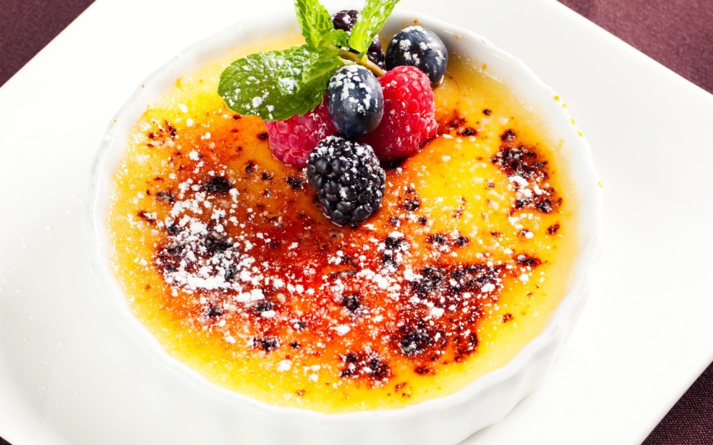 Vanilla bean creme brulee served with fresh berries