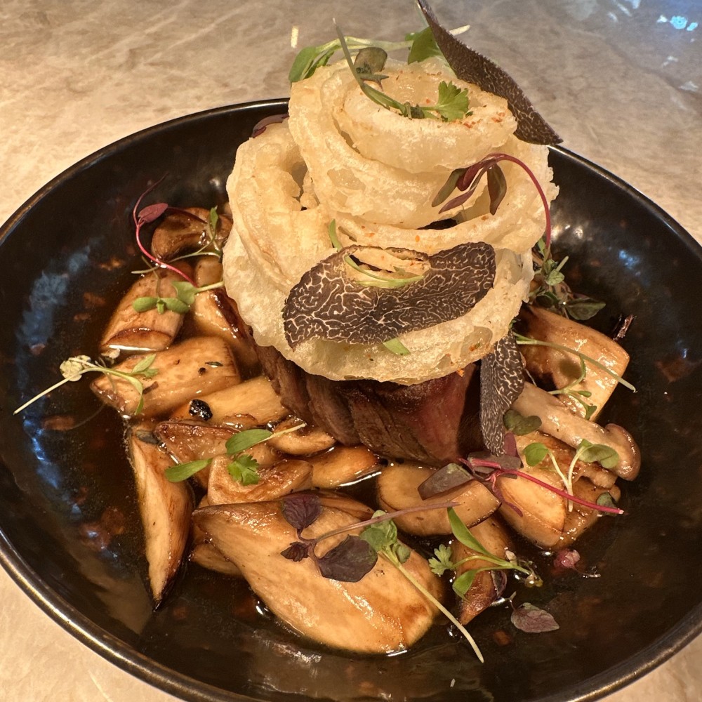 Roasted Japanese mushroom, truffle butter emulsion, crispy spiced onion rings.