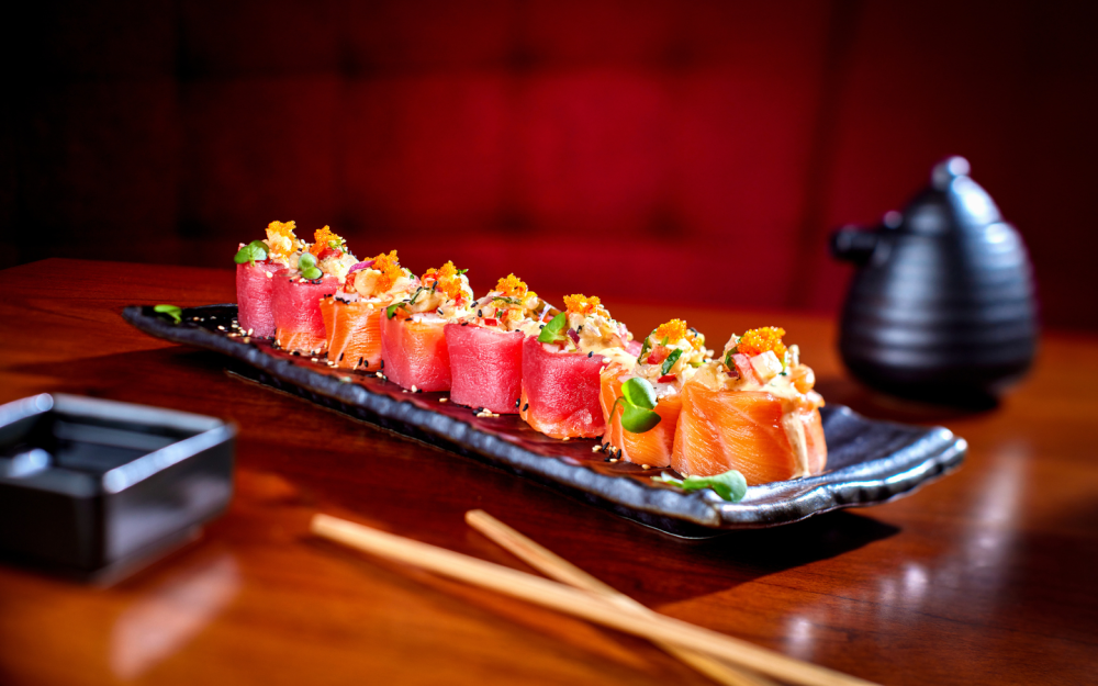 Rice-less protein roll. Tobiko, shrimp, kani and avocado. Topped with salmon and tuna, mix ceviche and sesame seeds.