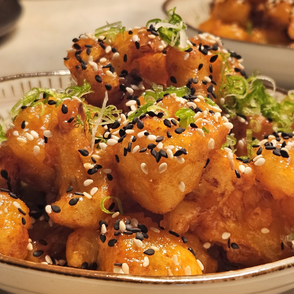 Crispy cauliflower, gochujang glaze, negi, mixed sesame seeds