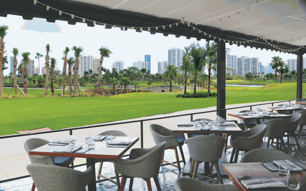 Dine amongst nature with the beautiful view of the Soffer and Miller golf course, swaying palm trees and fresh air.